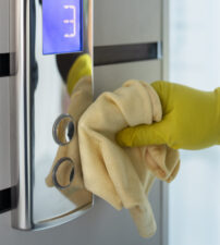 hand-cleaning-elevator-buttons-with-cloth